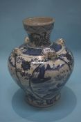 An archaic Chinese blue and white vase, decorated with panels of landscapes