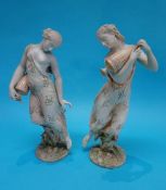 A pair of Continental porcelain figures of semi nude classical figures, each holding ewers,