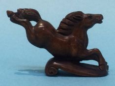A carved netsuke in the form of a horse