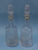 A pair of Asprey of London silver mounted and cut glass decanters