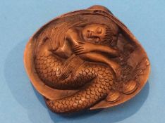 A carved netsuke in the form of a mermaid