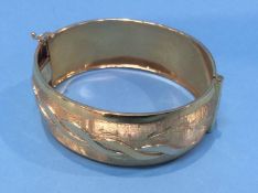 A gold bangle stamped '750', 39.8 grams