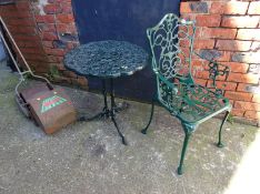 A cast garden table and chair