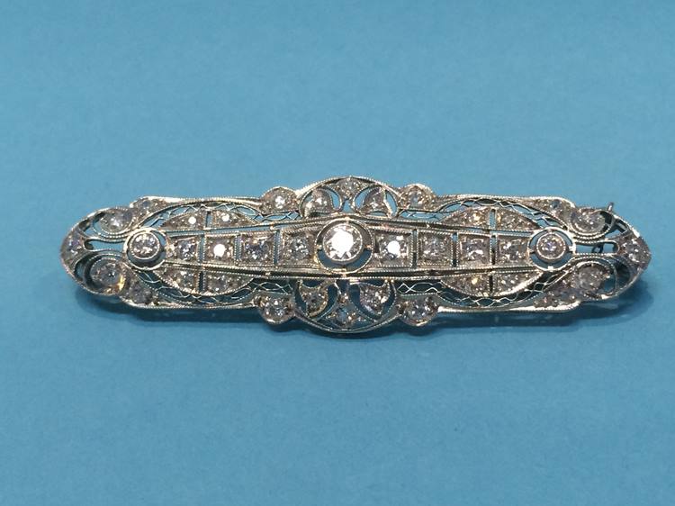 A diamond set white metal brooch