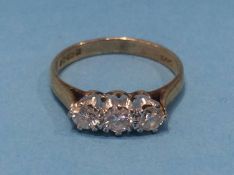 A 9ct three stone diamond ring, size 'K', 2 grams