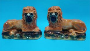 A pair of Staffordshire lions