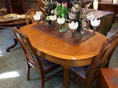 A teak dining table and chairs