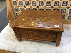 A carved oak sewing box