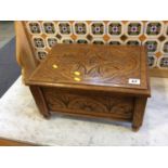 A carved oak sewing box