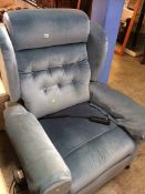 A blue velour electric arm chair