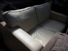 A cream leather two seater sofa