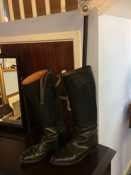 A pair of riding boots and a shooting stick