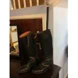 A pair of riding boots and a shooting stick