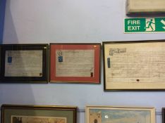 A collection of three framed indentures