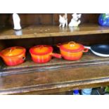 Four Le Creuset pans