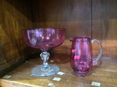 A Cranberry glass jug and a bowl
