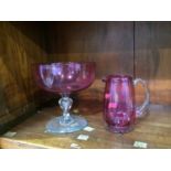 A Cranberry glass jug and a bowl