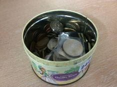Assorted coins etc. in a tin