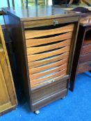 A mahogany tambour front filing cabinet