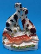 A 19th century Staffordshire flatback group of two Spaniels with a deer lying at their feet, 18.