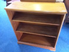 A teak fall front drinks cabinet and an open bookcase