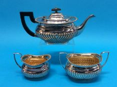 A silver plated semi-fluted three piece tea set