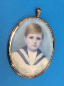 A miniature portrait of a boy, in yellow metal frame