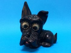 A carved wood German Scottie dog with clock work rolling eyes