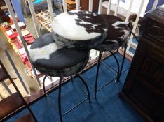 Three revolving stools with cow skin seat pads (1 a/f)