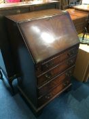 A reproduction mahogany bureau