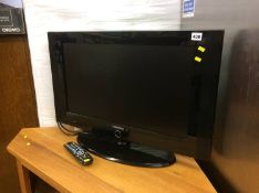 A Samsung television (remote in office)