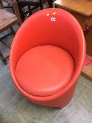 An orange Evans furniture tub chair