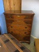 A walnut bow front chest of drawers