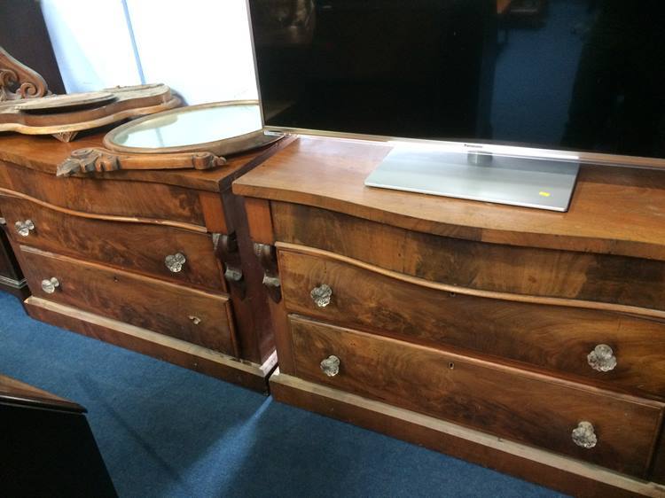 A pair of 19th Century mahogany serpentine fronted three drawer chests, 106 cm wide