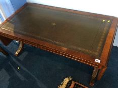 A reproduction mahogany drop flap table, with inset leather top