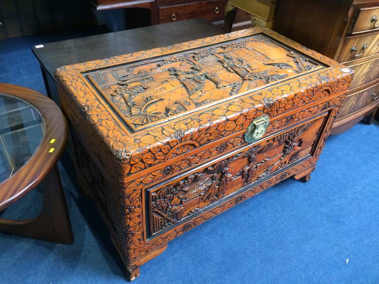 A carved Oriental camphorwood chest