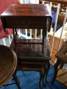 A reproduction nest of tables and a drop leaf table