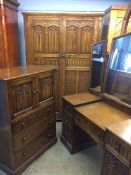 An oak linenfold three piece bedroom suite