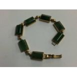 A jade bracelet with 9ct mount