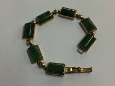 A jade bracelet with 9ct mount