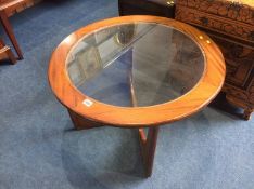 A teak and glass circular oak table