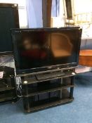 A Sony television and stand (remote in office)