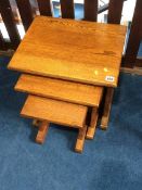 An oak nest of three tables