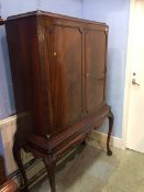 A reproduction mahogany drinks cabinet with fitted interior