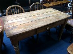 A pine plank top kitchen table