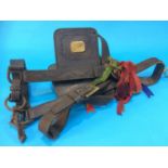 An antique leather horse bridle and brasses