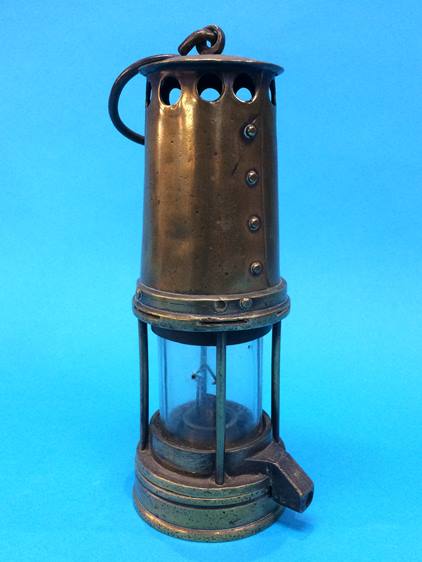 A brass four bar miners lamp