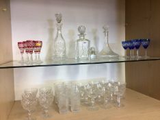 Three decanters and a quantity of cut and coloured glass