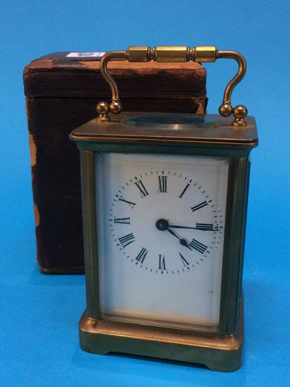 A brass four glass carriage clock together with fitted travel case