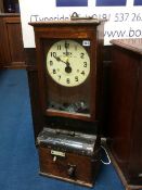 An oak cased clocking in clock, Time Recorders Ltd